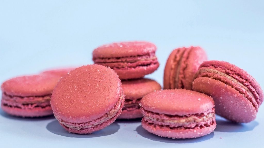Pink macarons on a powder blue background
